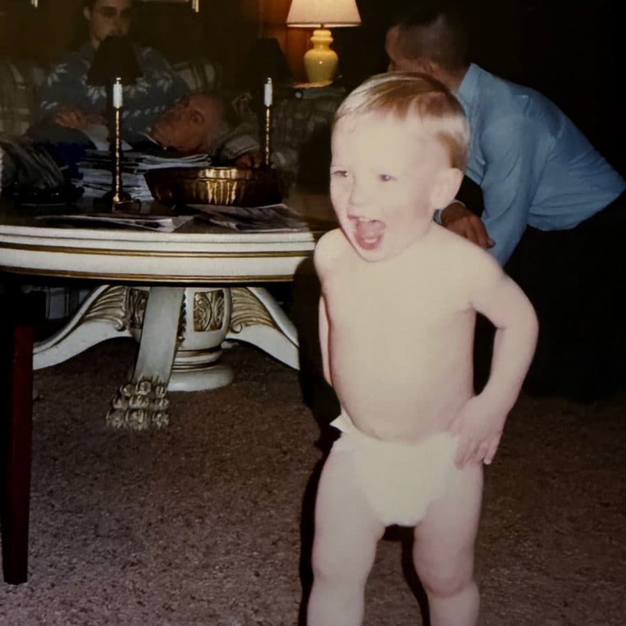 Barrett as a toddler in a diaper, mid-yell, in a living room in June 1989